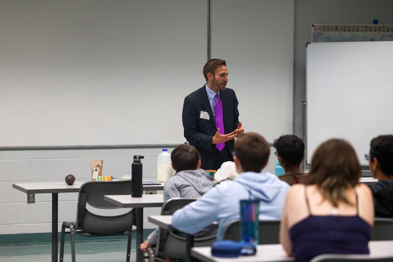 Drew Anderson speaking with students